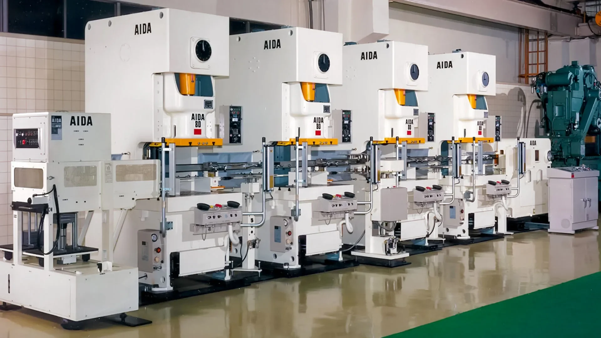 Mechanical presses and tooling tables along a Himgo workshop floor in Shenzhen